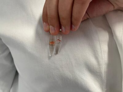 Schüler hält Probenbecher